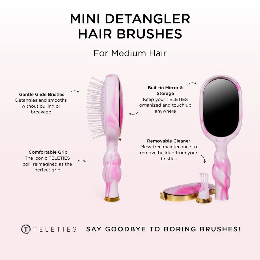 Pink mini detangler hair brush with mirror and cleaning tool on a white background