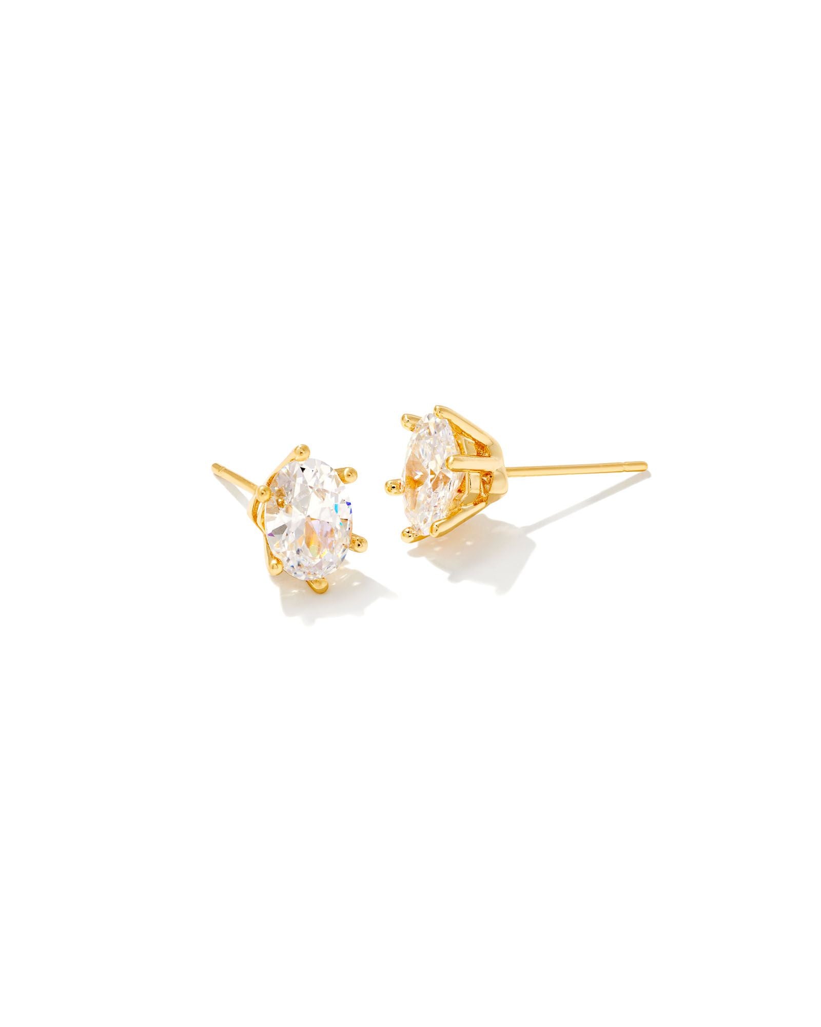 A pair of gold metal stud earrings with white cubic zirconium stones.