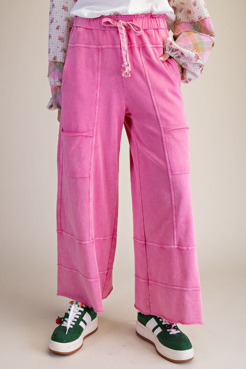 Person wearing pink pants with a neutral background