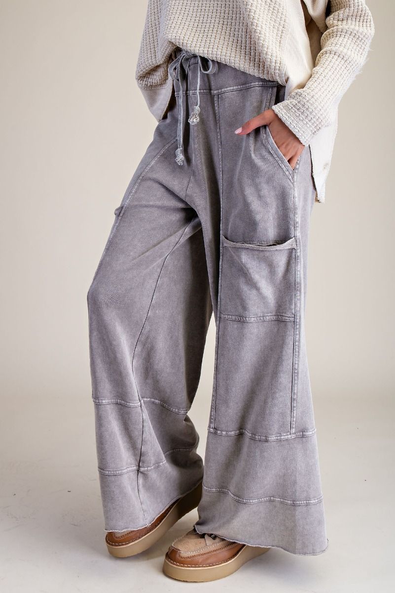 Person wearing light gray wide-leg pants with a neutral background