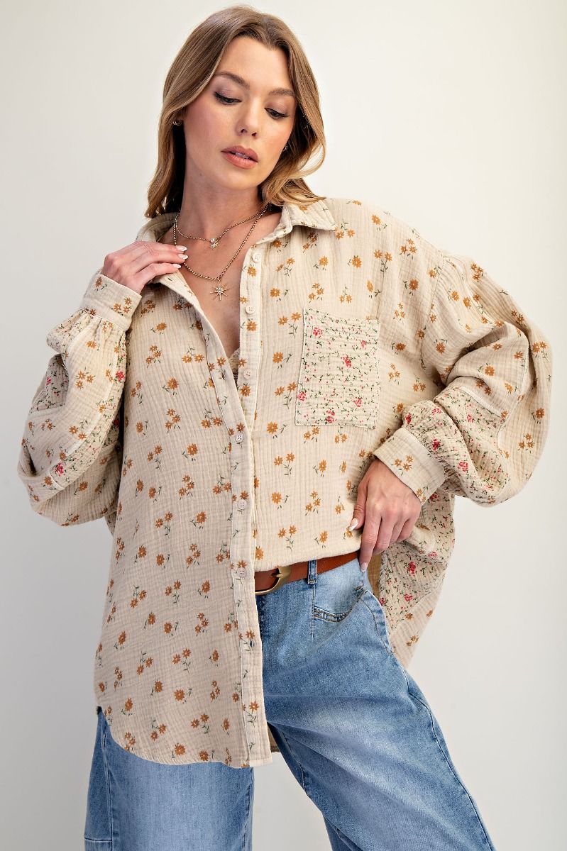 Woman wearing a floral blouse and jeans on a white background