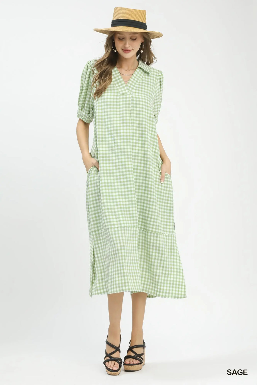 Woman modeling a sage green gingham midi dress