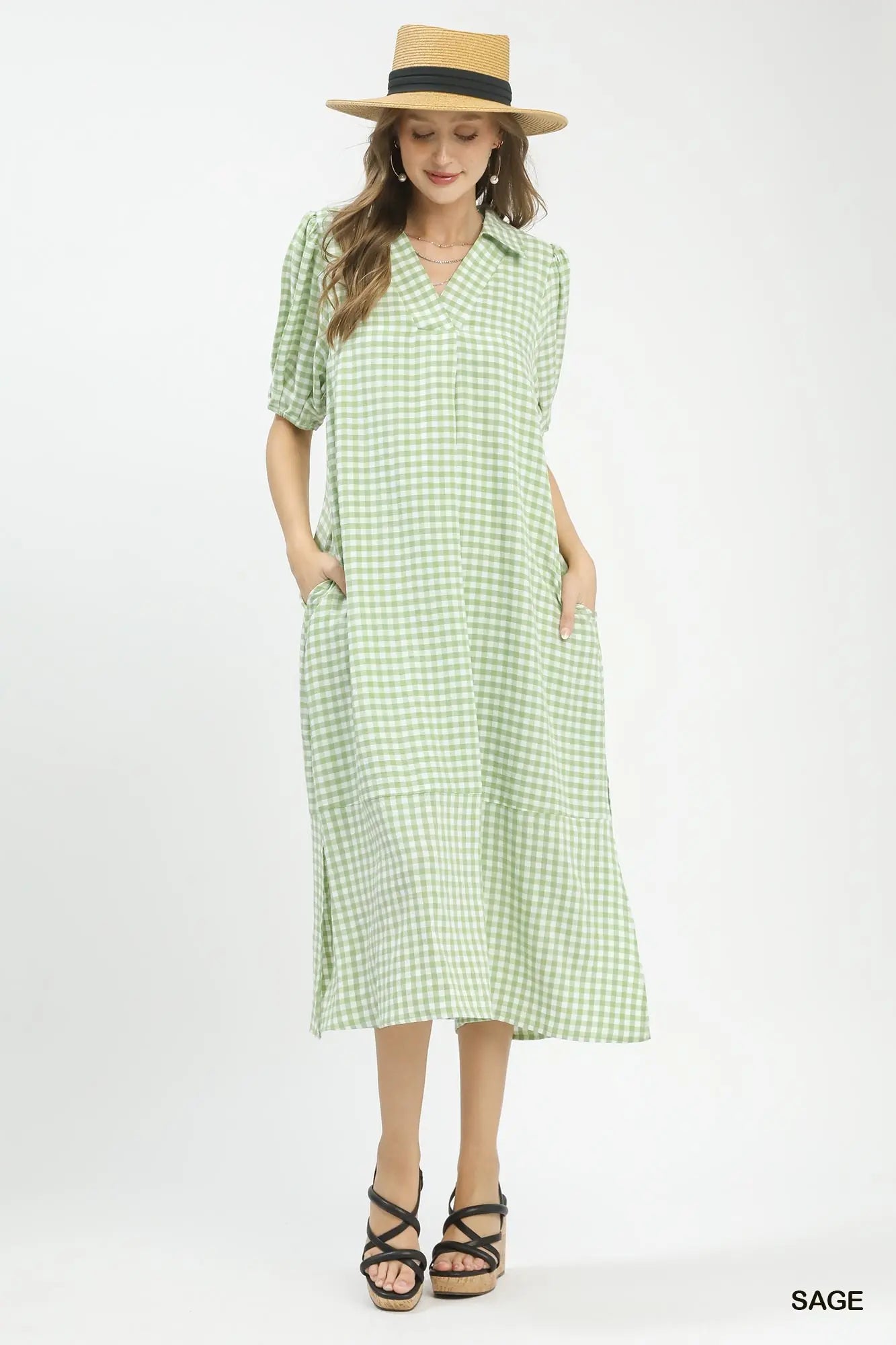 Woman modeling a sage green gingham midi dress