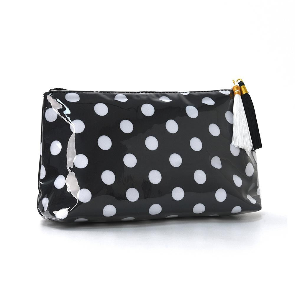 A glossy black cosmetic pouch with white polka dots and a black and white tassel zipper pull, shown on a plain white background.