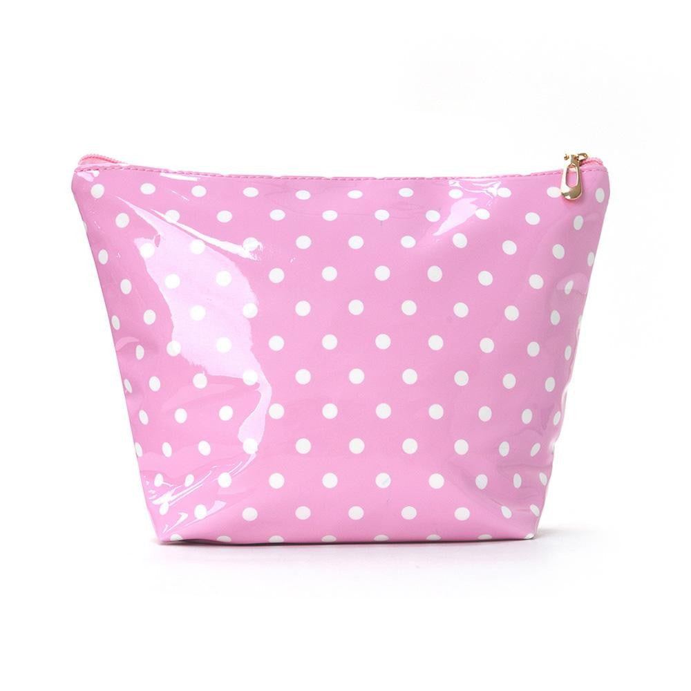 A pink glossy cosmetic pouch with a white polka dot pattern and a gold zipper pull, shown on a plain white background.