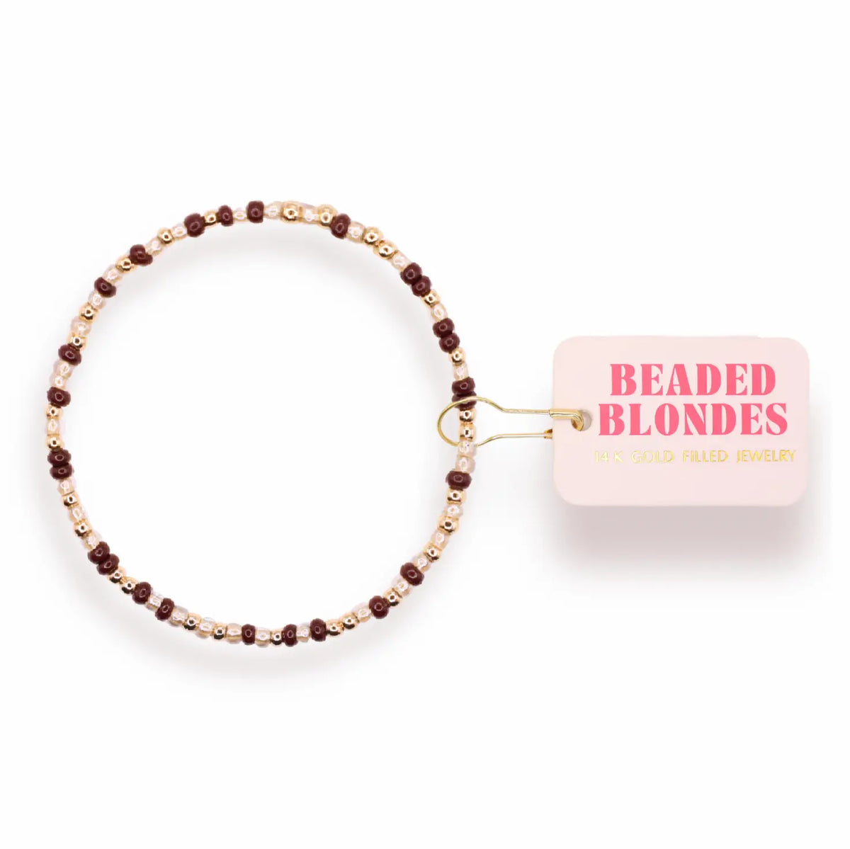 A beaded stretch bracelet with dark brown beads, light pink beads, and small gold spacer beads, shown with a pink tag that reads 'BEADED BLONDES'.