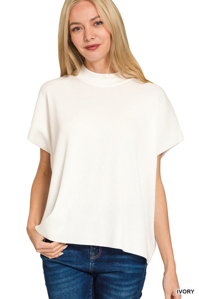Woman wearing a white t-shirt and blue jeans on a white background