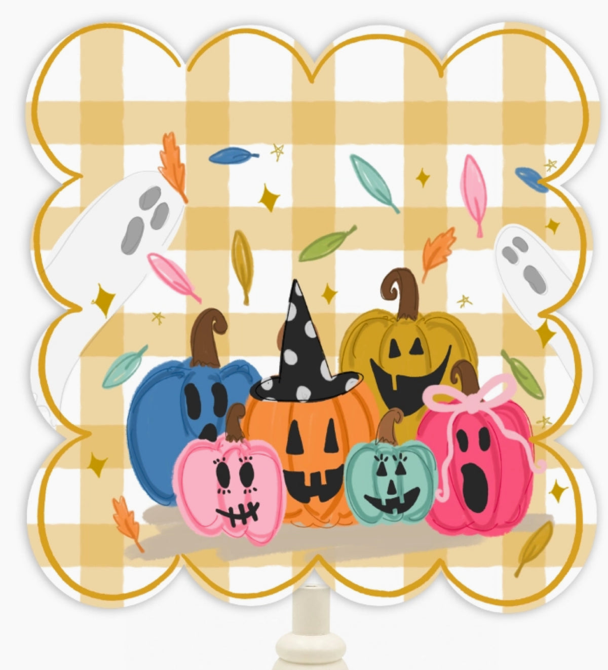 A scalloped decorative sign or sticker featuring a Halloween illustration with five cartoon pumpkins in blue, orange, teal, pink, and yellow, ghosts, leaves, and stars on a tan-and-white gingham background. A white stick or stand is visible at the bottom.