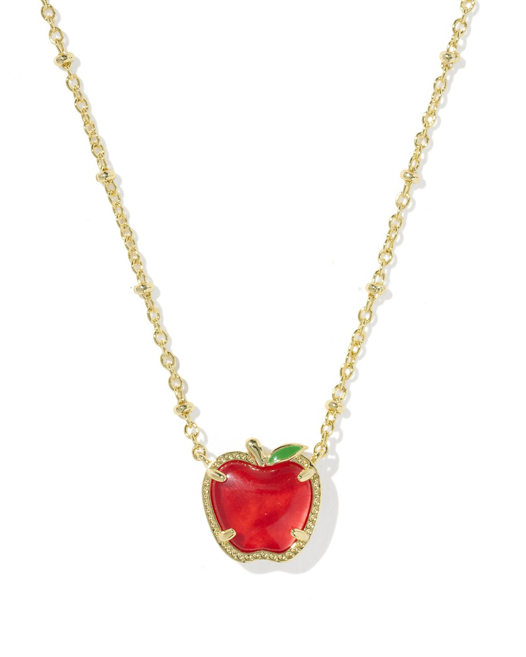 Red apple pendant necklace with gold chain on a white background