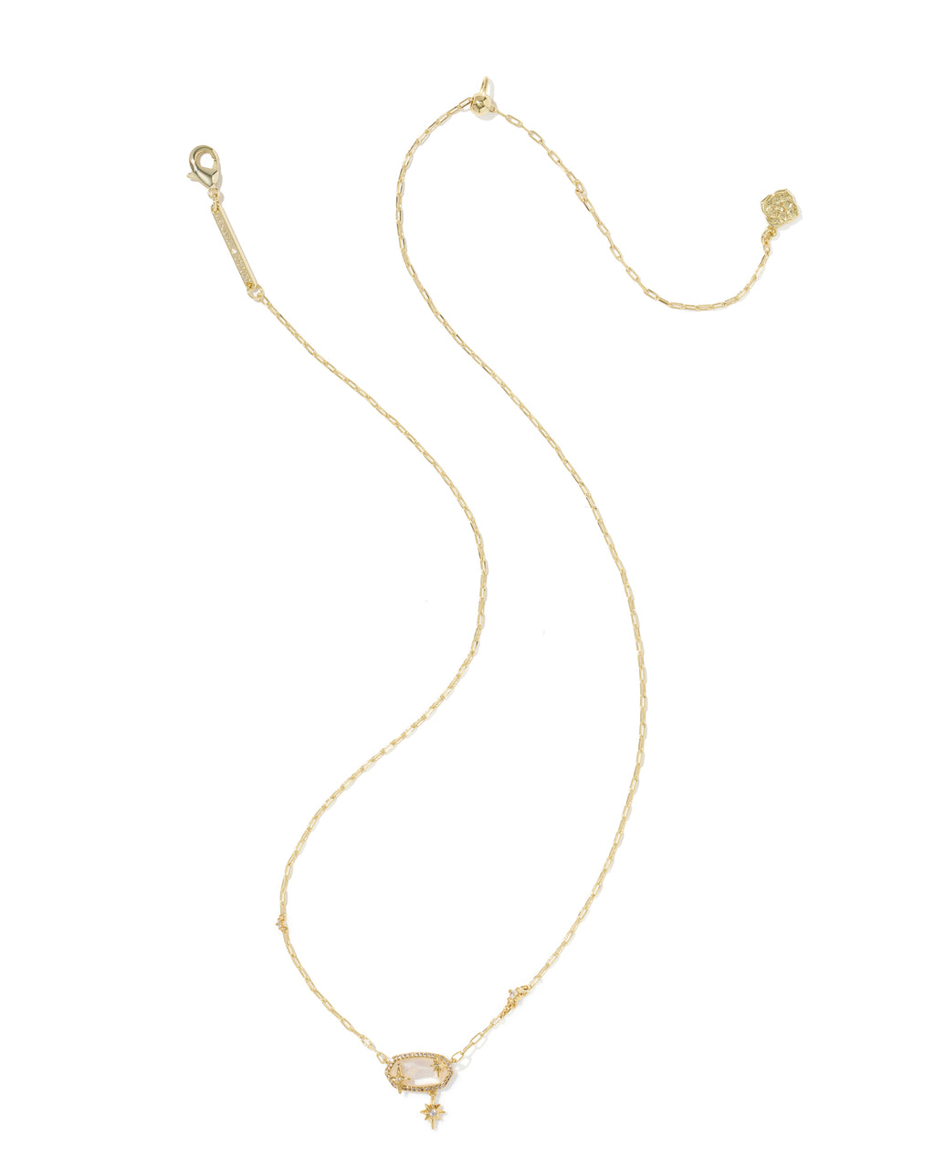A delicate gold chain necklace with a small rectangular clear gemstone pendant and a tiny dangling charm, displayed on a solid white background.