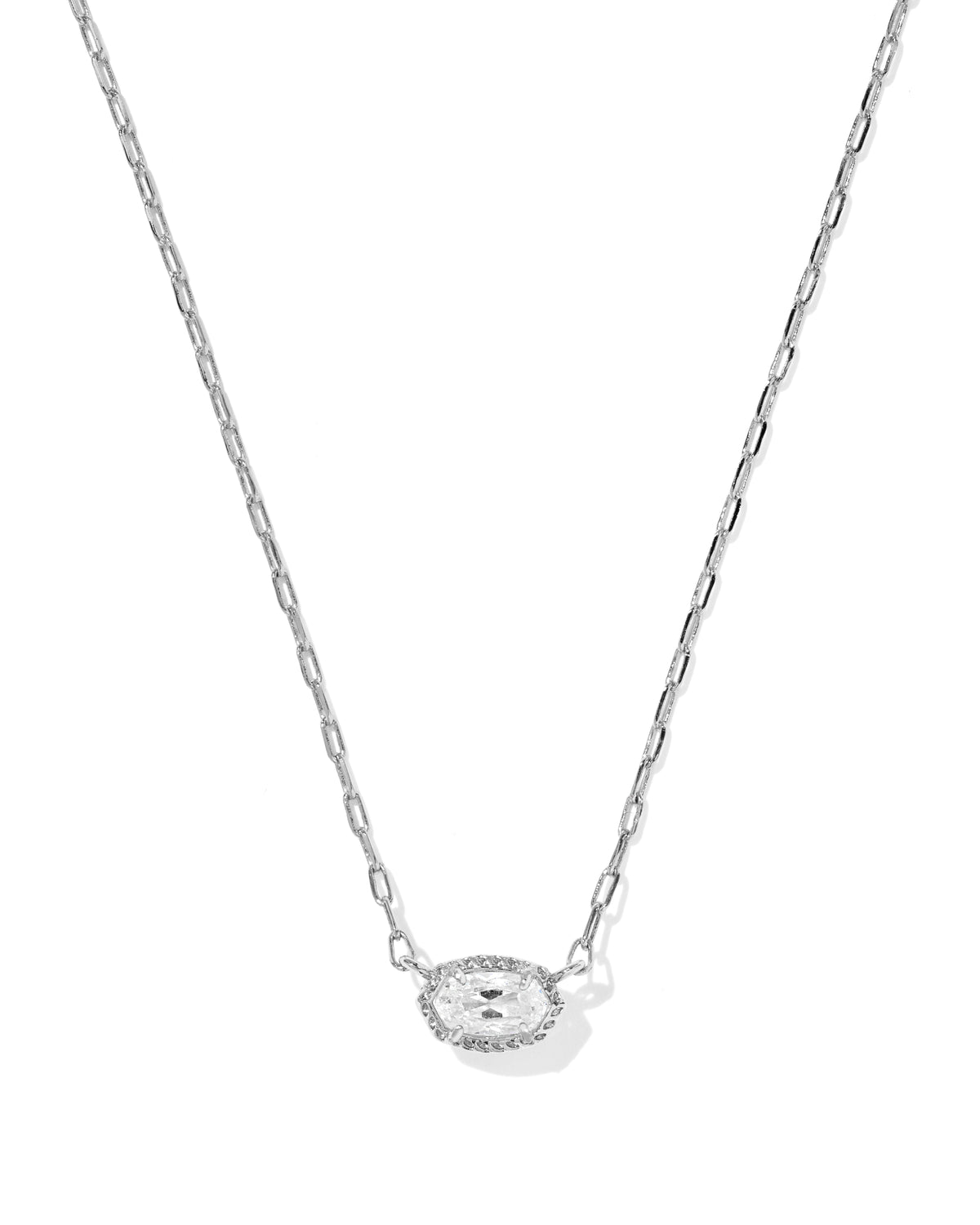A delicate silver chain necklace featuring a small oval pendant with a halo of tiny clear stones around a central clear gemstone, displayed on a clean white background.