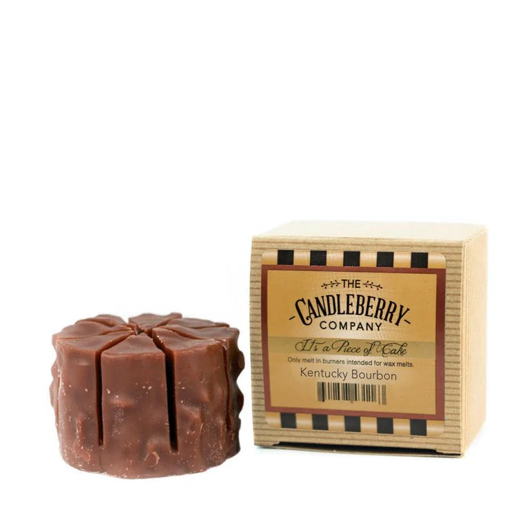 A wax melt tart with a brown color, resembling a bourbon bottle, placed next to its packaging box labeled 'Kentucky Bourbon'.