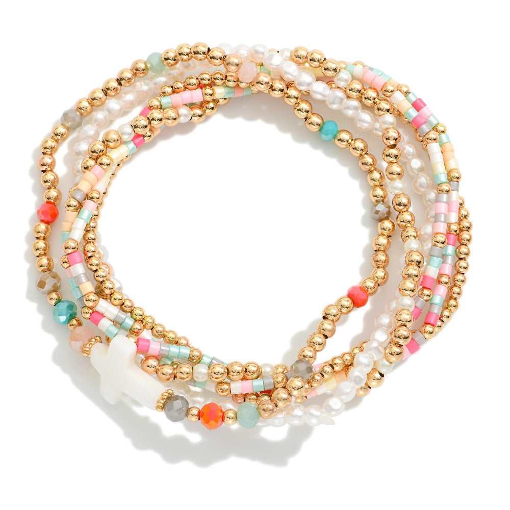 Stack of colorful beaded bracelets on a white background