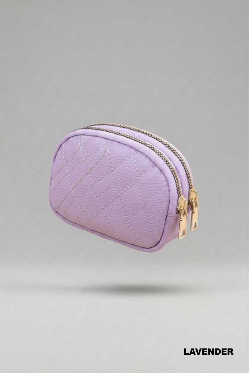 Lavender coin purse with gold double zippers against a grey background