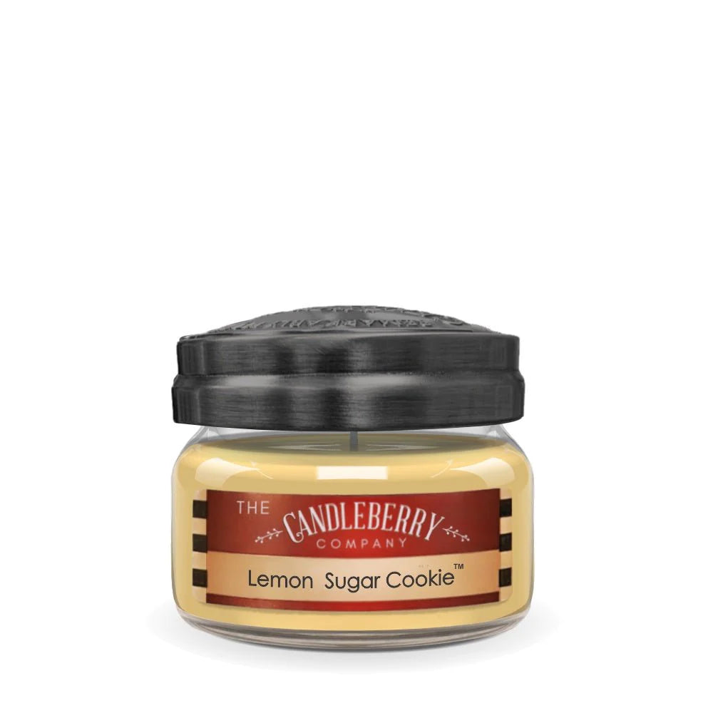 A small clear jar with a black lid labeled 'The Candleberry Company Lemon Sugar Cookie'.