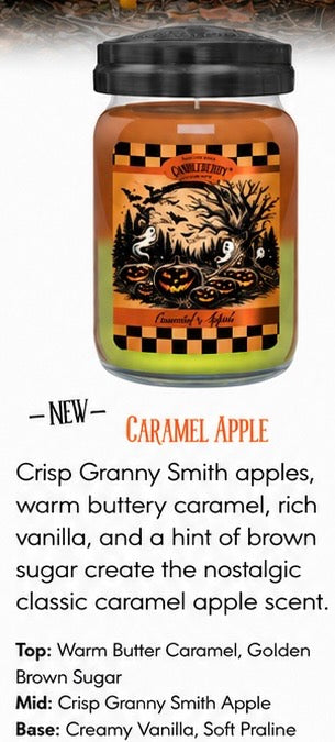 A candle in a clear glass jar with a black lid and a Halloween-themed label reading 'Caramel Apple.' The label shows an orange-brown apple illustration with black checkers and text describing the scent notes.