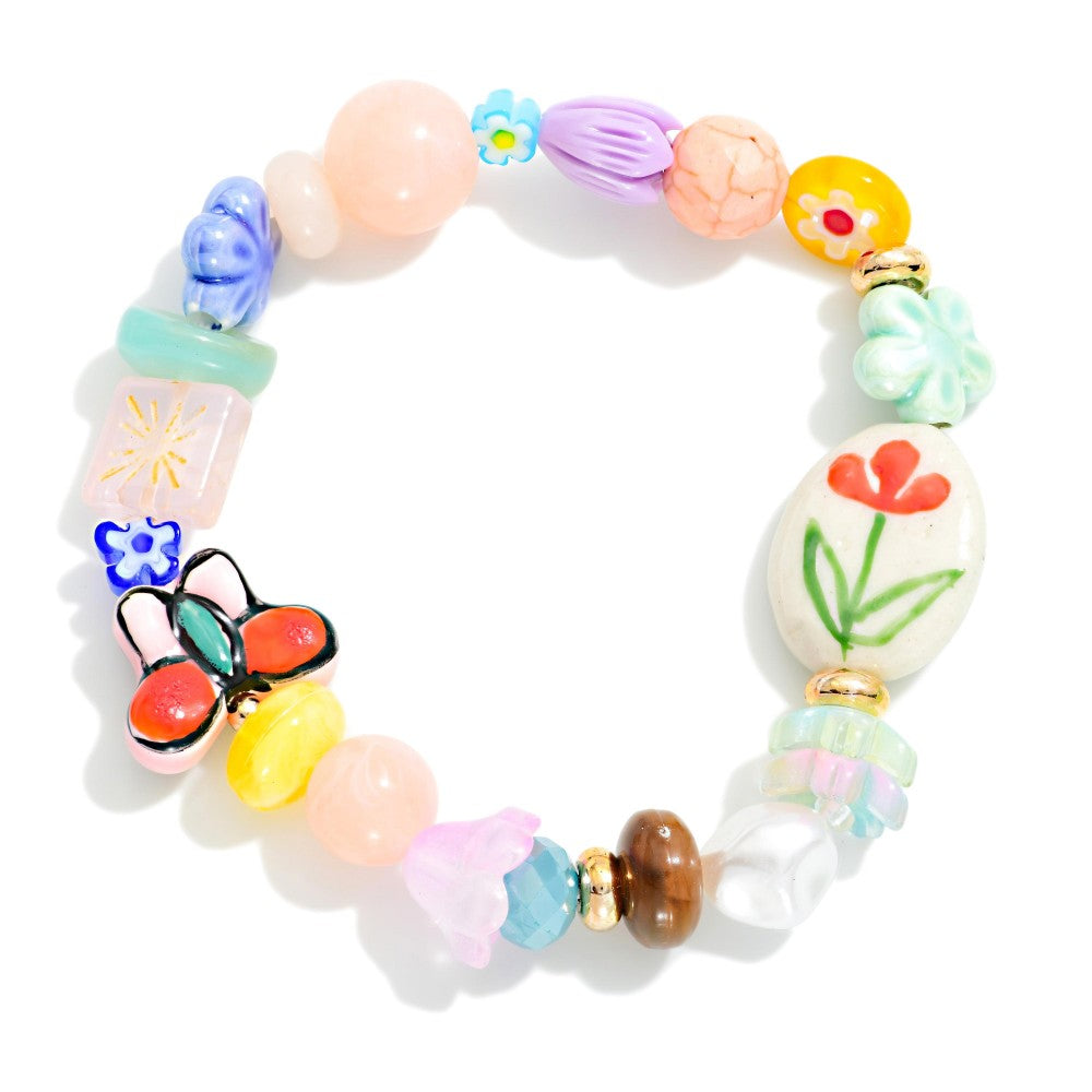 Beaded bracelet featuring flowers and butterfly beads on a white background 