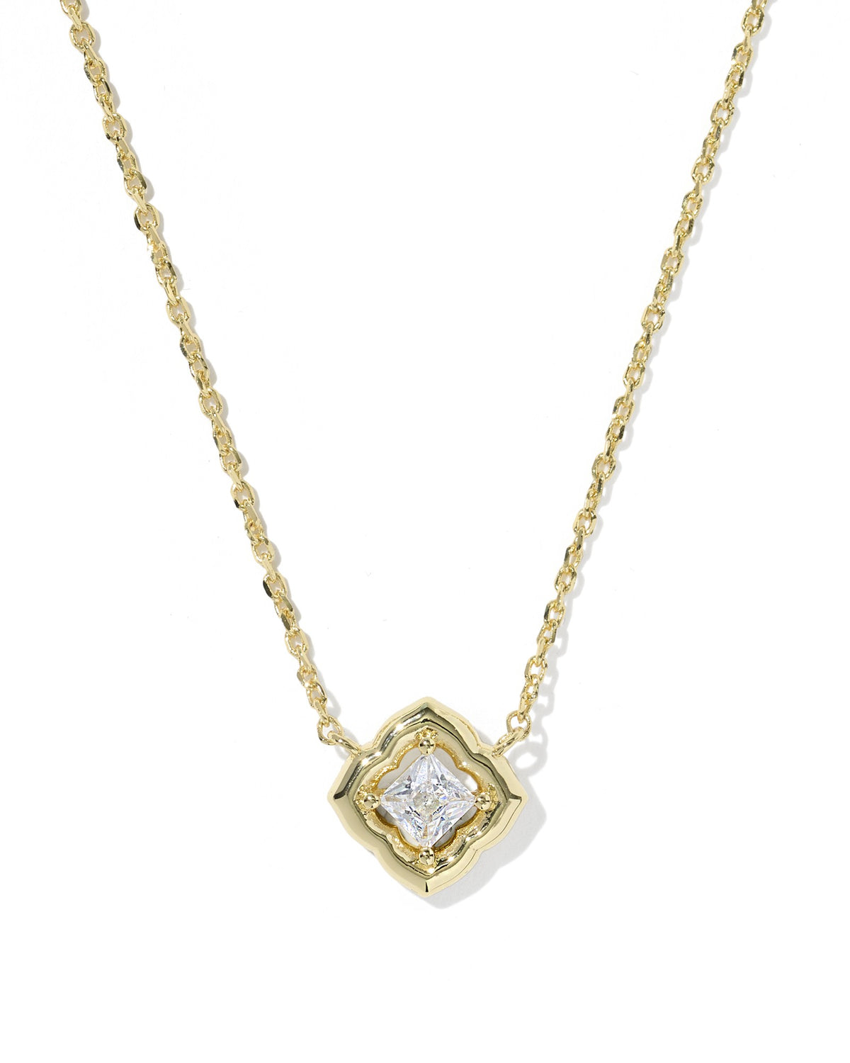 Gold necklace with a diamond pendant on a white background