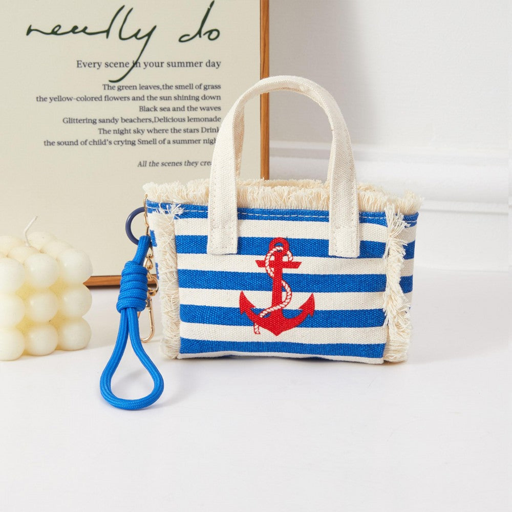 Blue and white stripped miniature handbag with red anchor on the front. Bag has clasp to act as a bag charm. 
