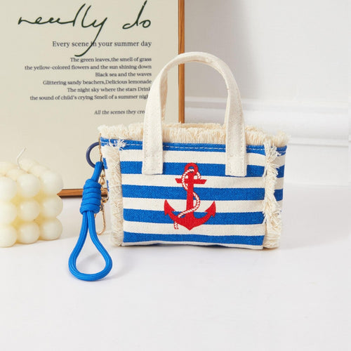 Blue and white stripped miniature handbag with red anchor on the front. Bag has clasp to act as a bag charm. 
