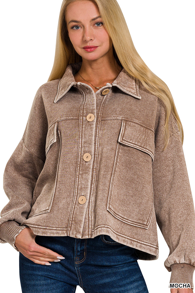 Woman wearing a brown jacket with a plain background