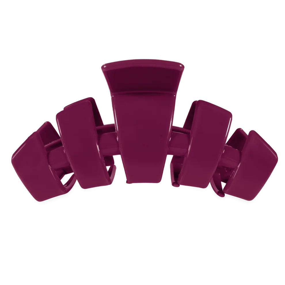 A glossy, deep magenta hair claw clip shown against a solid white background.