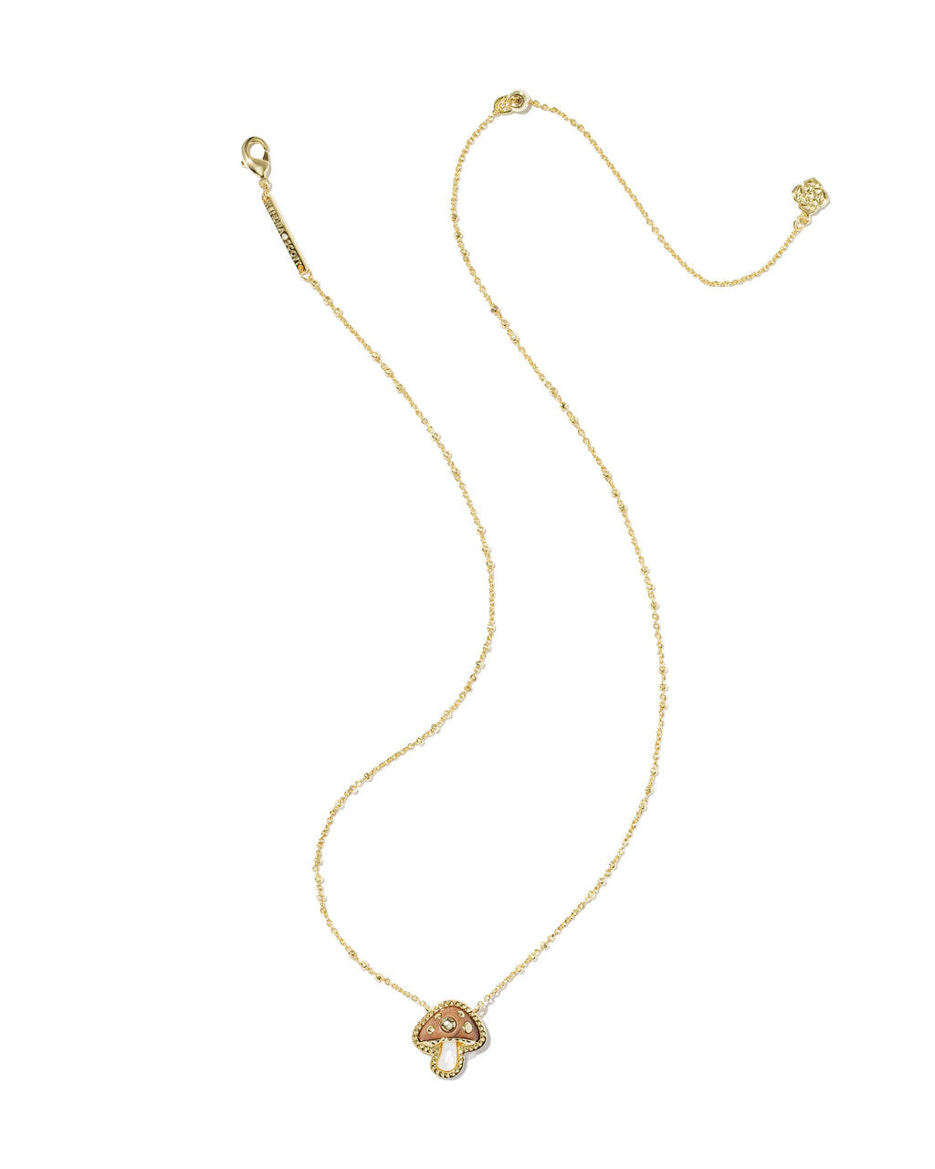 A delicate gold chain necklace featuring a small mushroom-shaped pendant with a textured, peachy-pink center, displayed on a clean white background.