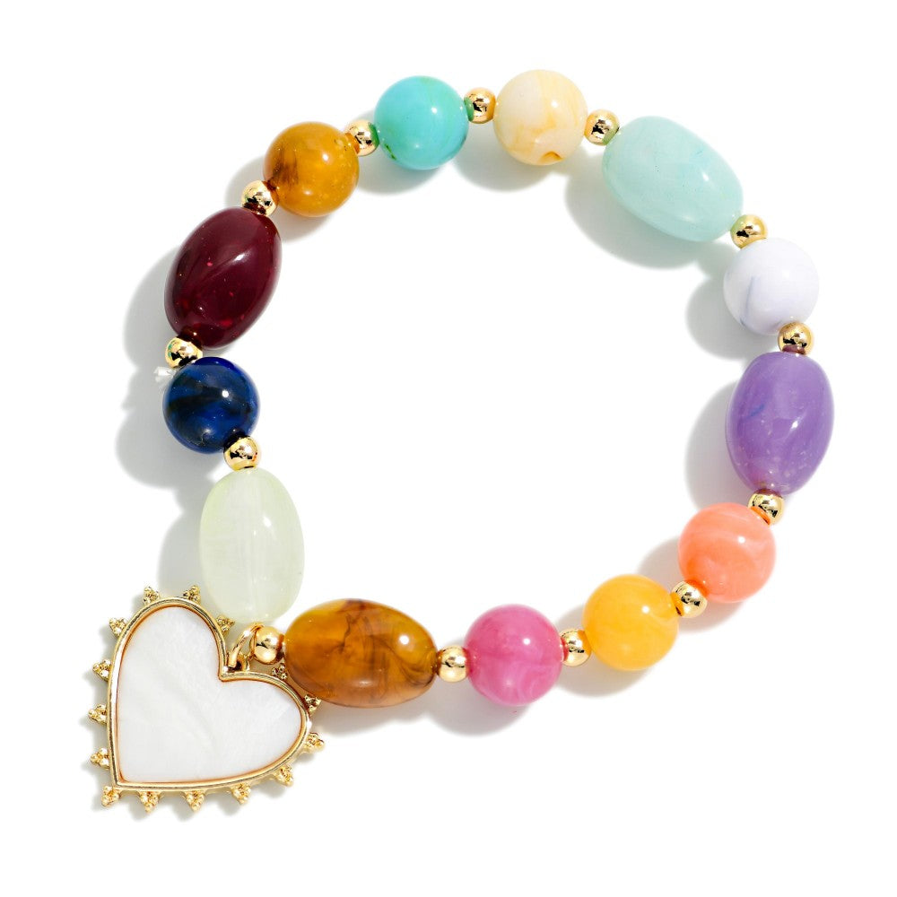 Multicolored beaded bracelet with a heart charm on a white background