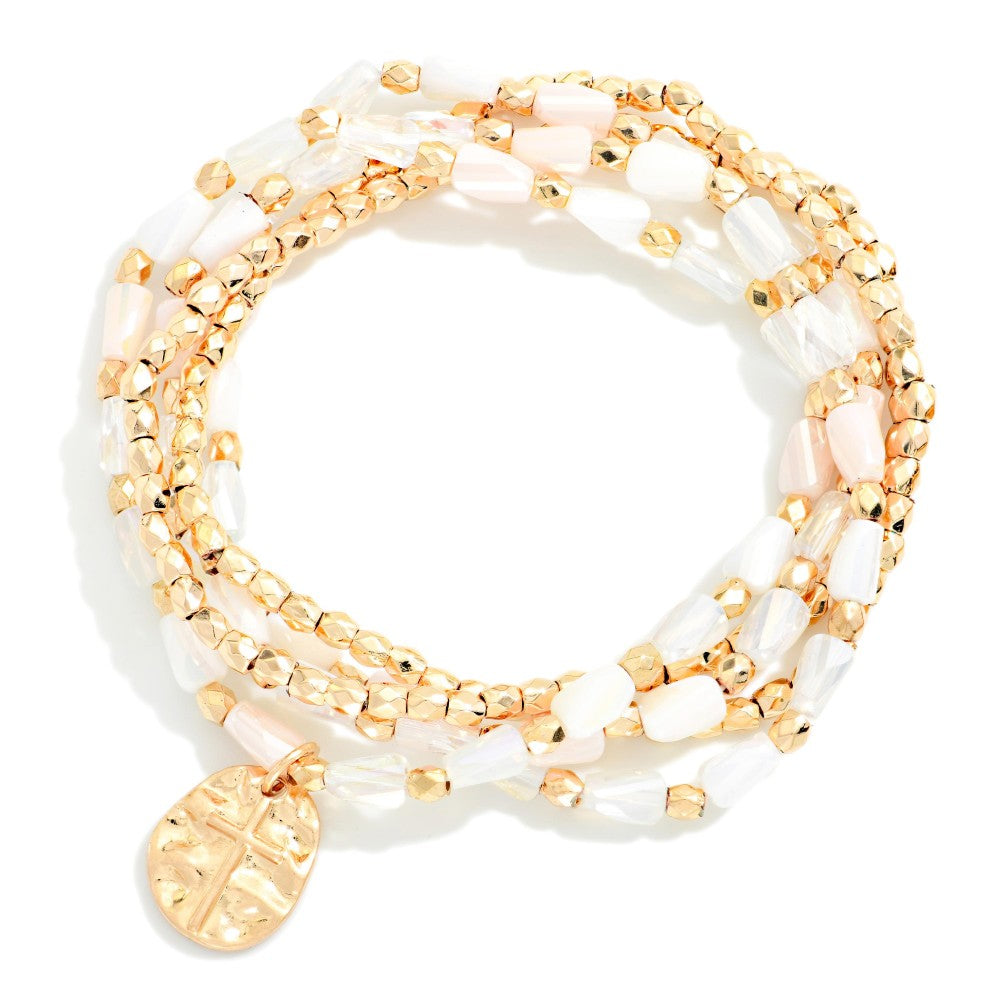 White and gold beaded bracelet set on a white background 