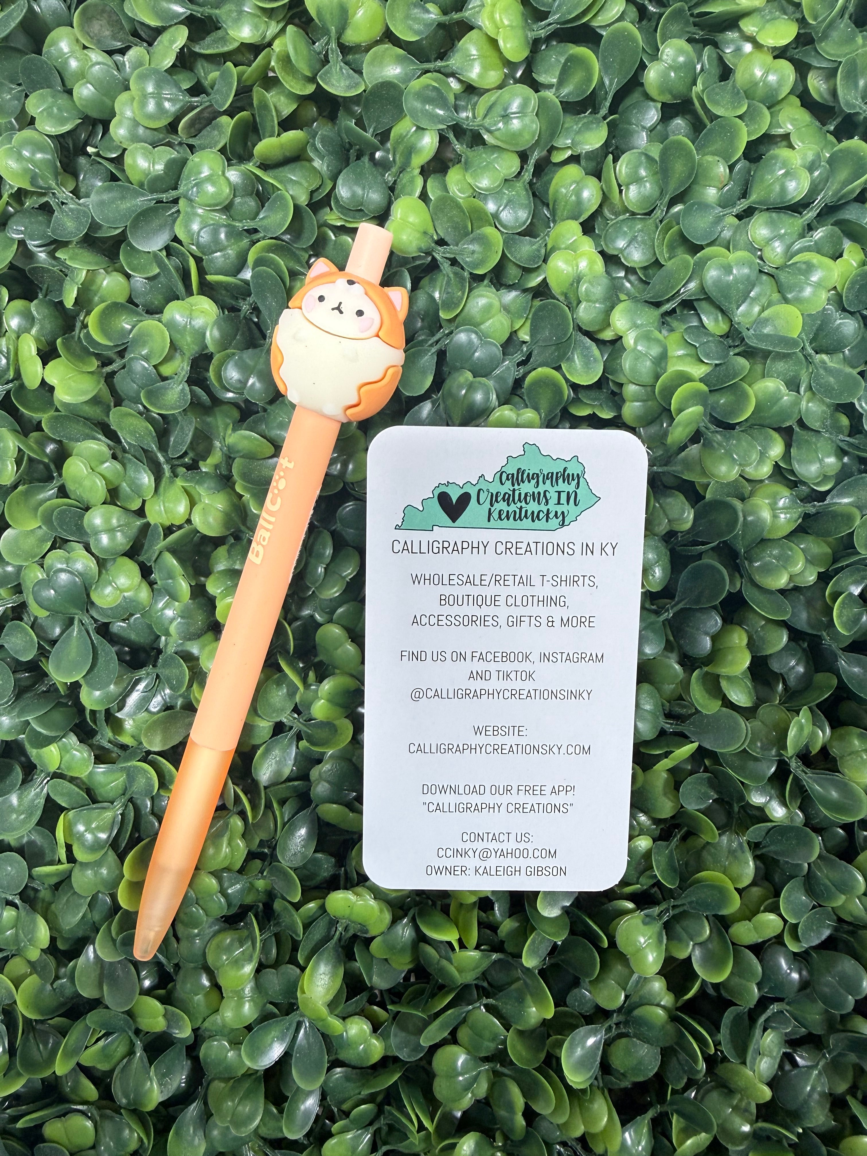 Ink pen with orange cat design on a green leafy background