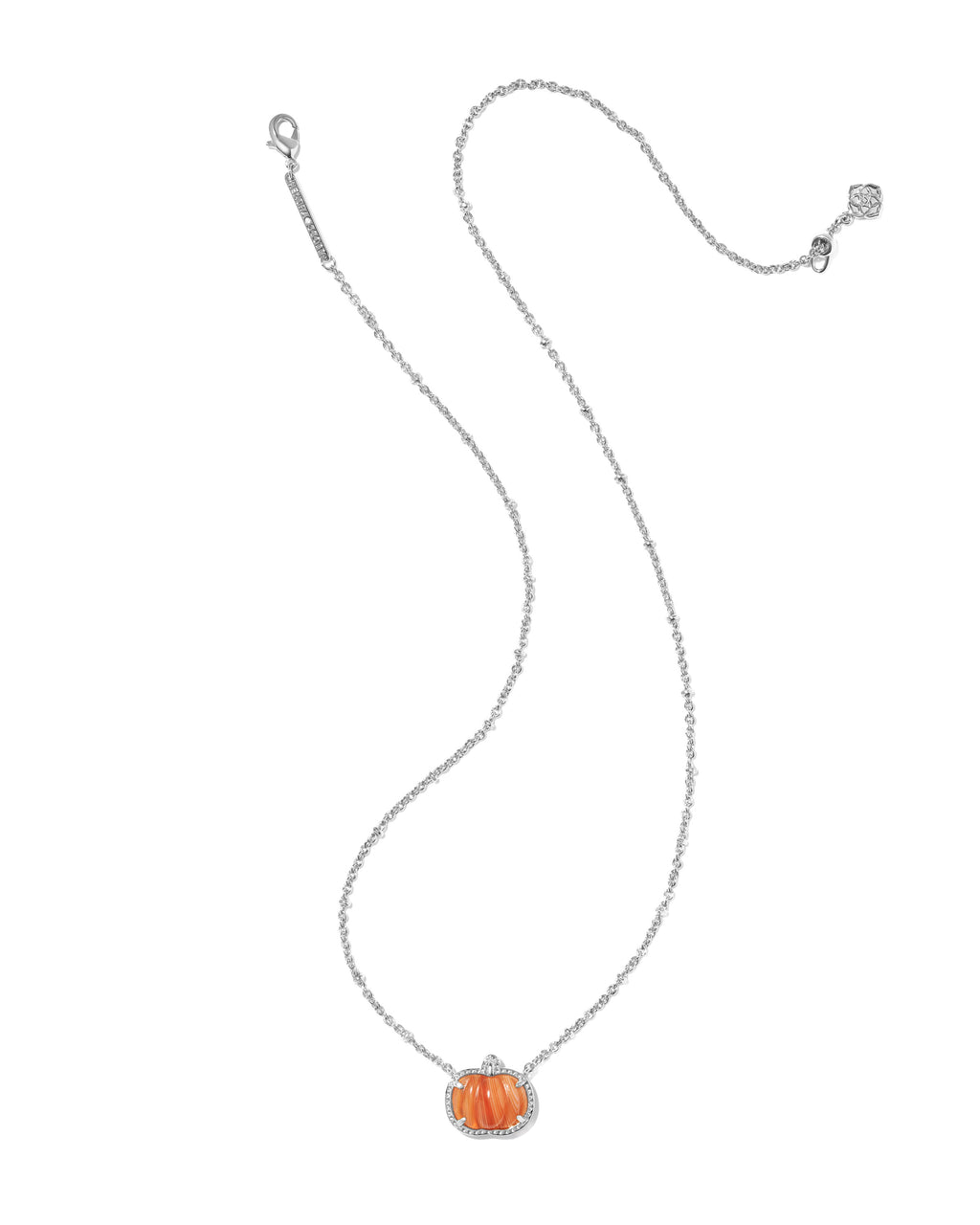 A delicate silver chain necklace featuring a small pumpkin-shaped pendant with orange detailing and a silver border, displayed on a clean white background.