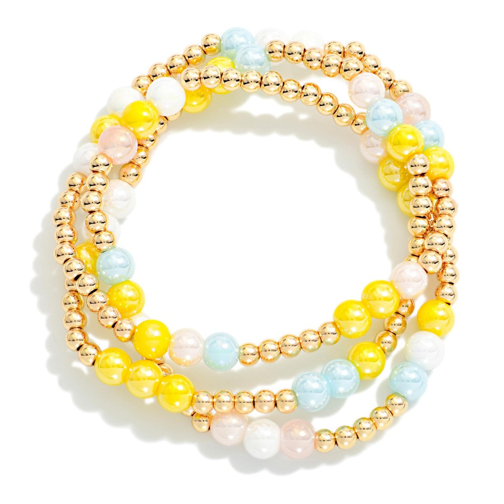 Set of colorful beaded bracelets on a white background