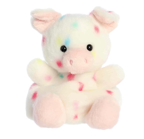 A plush pig toy with a soft white body, pink ears and snout, and scattered pastel confetti-like spots in pink, blue, yellow, and green, shown on a plain white background.