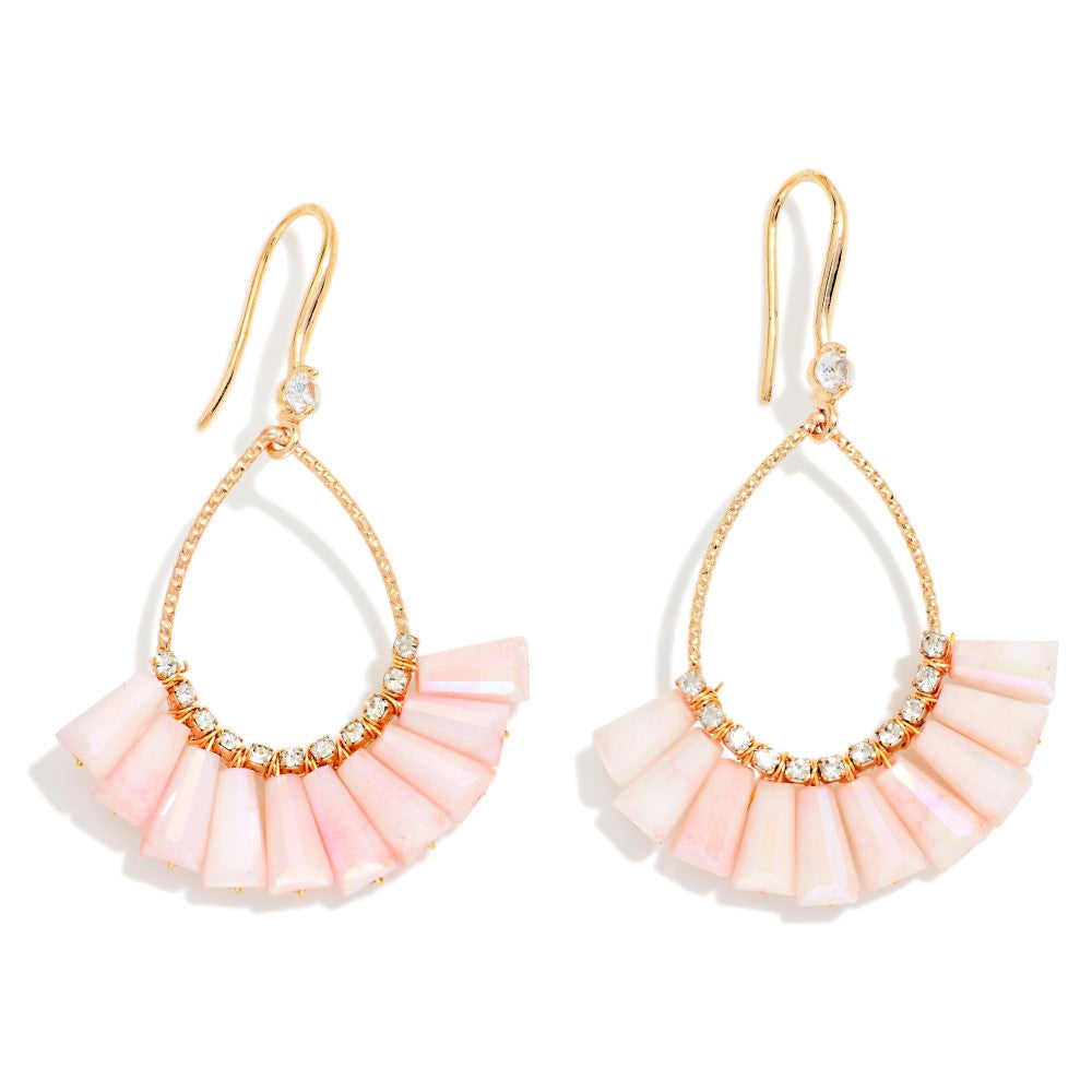 A pair of gold-tone drop earrings featuring a fan-shaped arrangement of pale pink shell-like pieces and small clear rhinestone accents, shown on a white background.