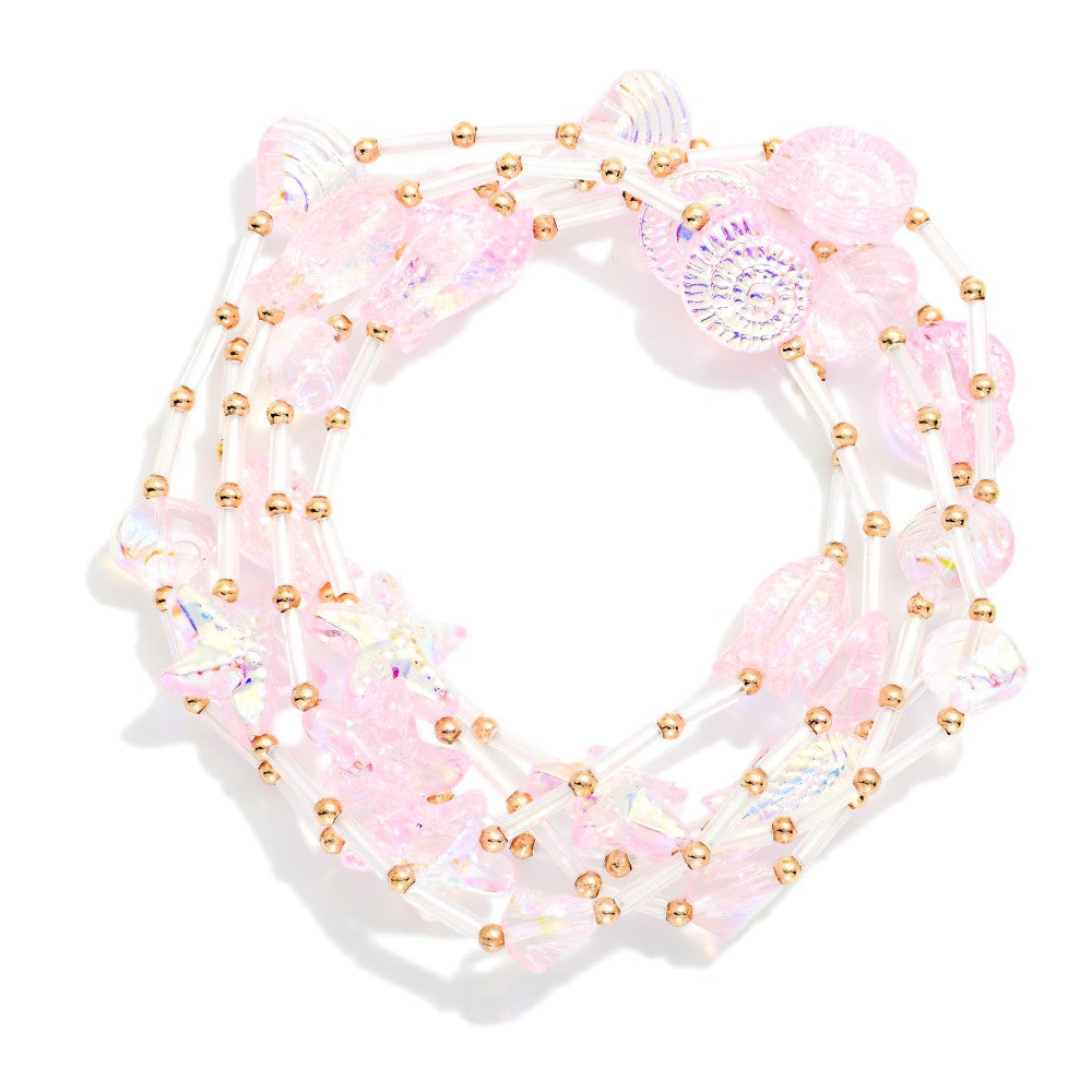 Pink bracelet set with seashells and starfish on a white background 