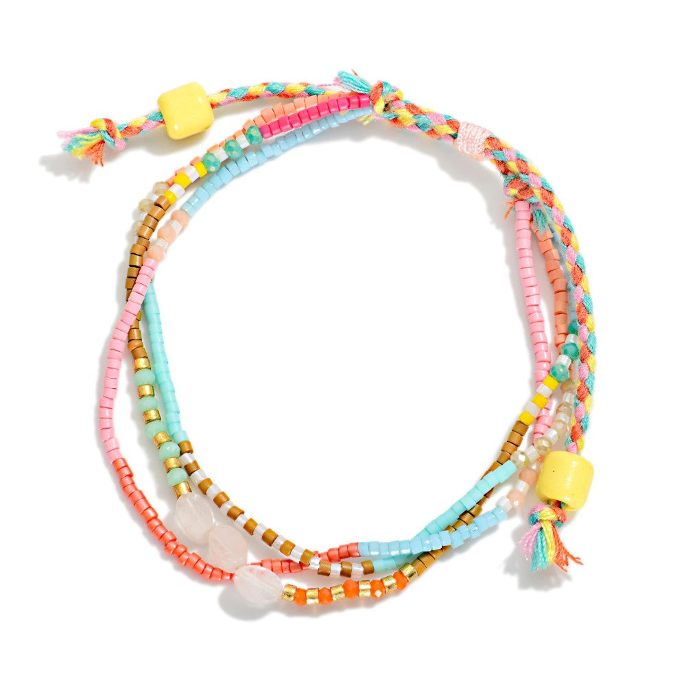Colorful beaded necklace with a yellow accent on a white background