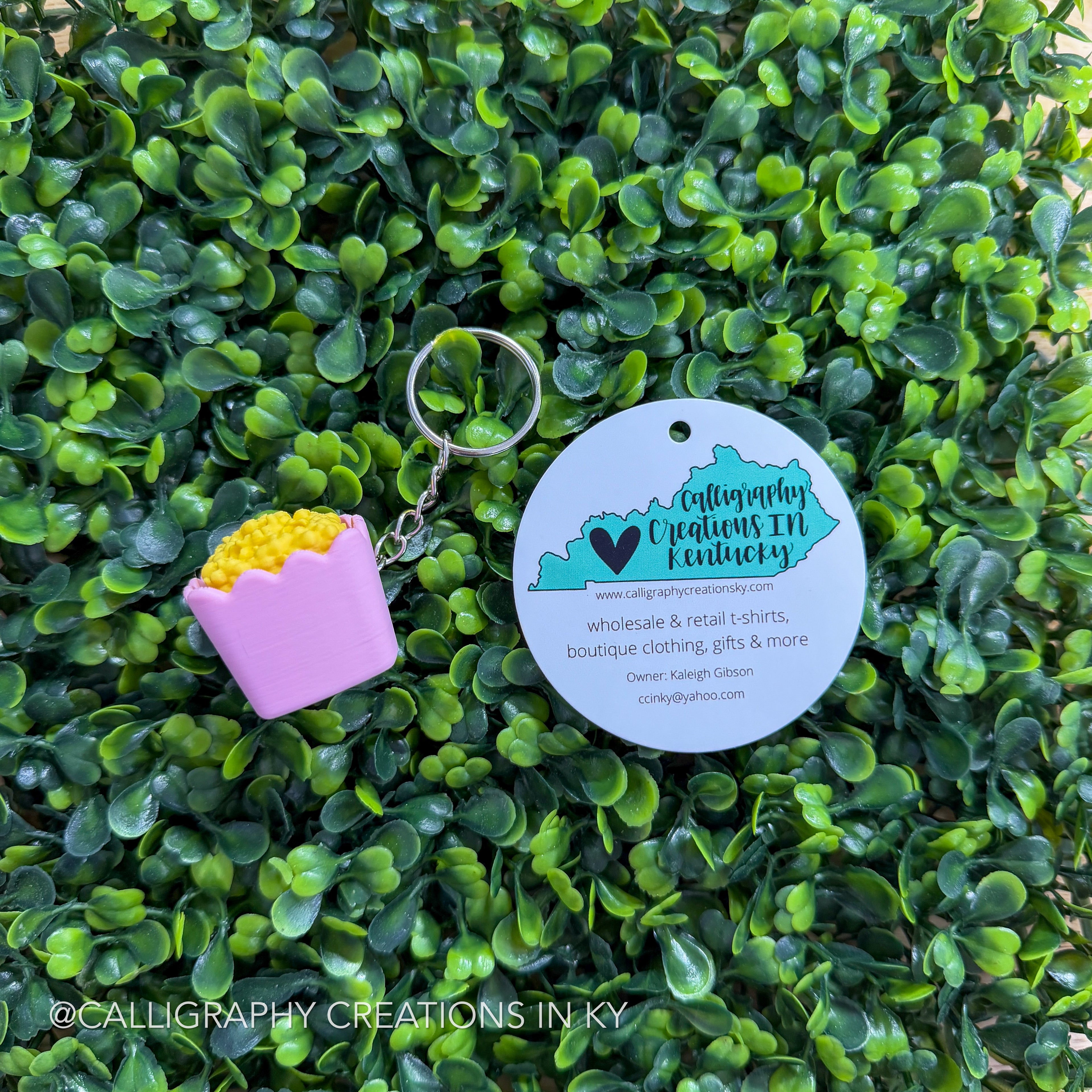 Pink popcorn fidget keychain on greenery background with Calligraphy Creations branding
