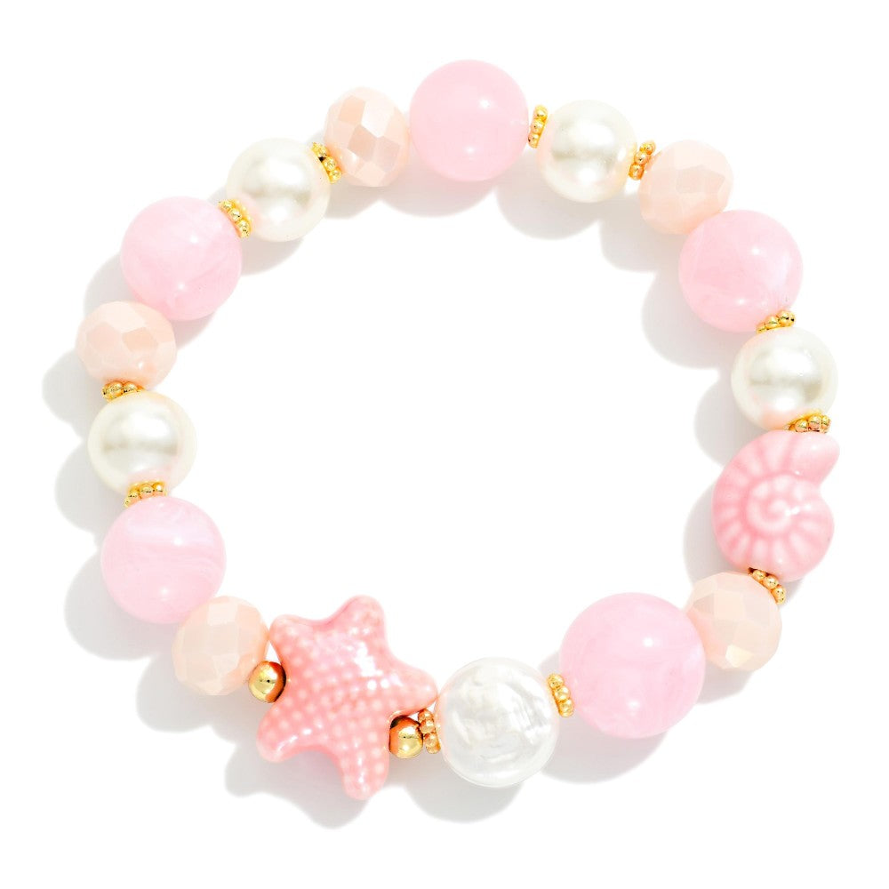 Pink and white beaded bracelet with starfish charm on a white background