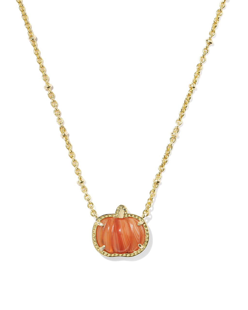 A gold chain necklace featuring a pumpkin-shaped pendant with a carved orange-pink shell center and a border of small clear stones, shown on a plain white background.