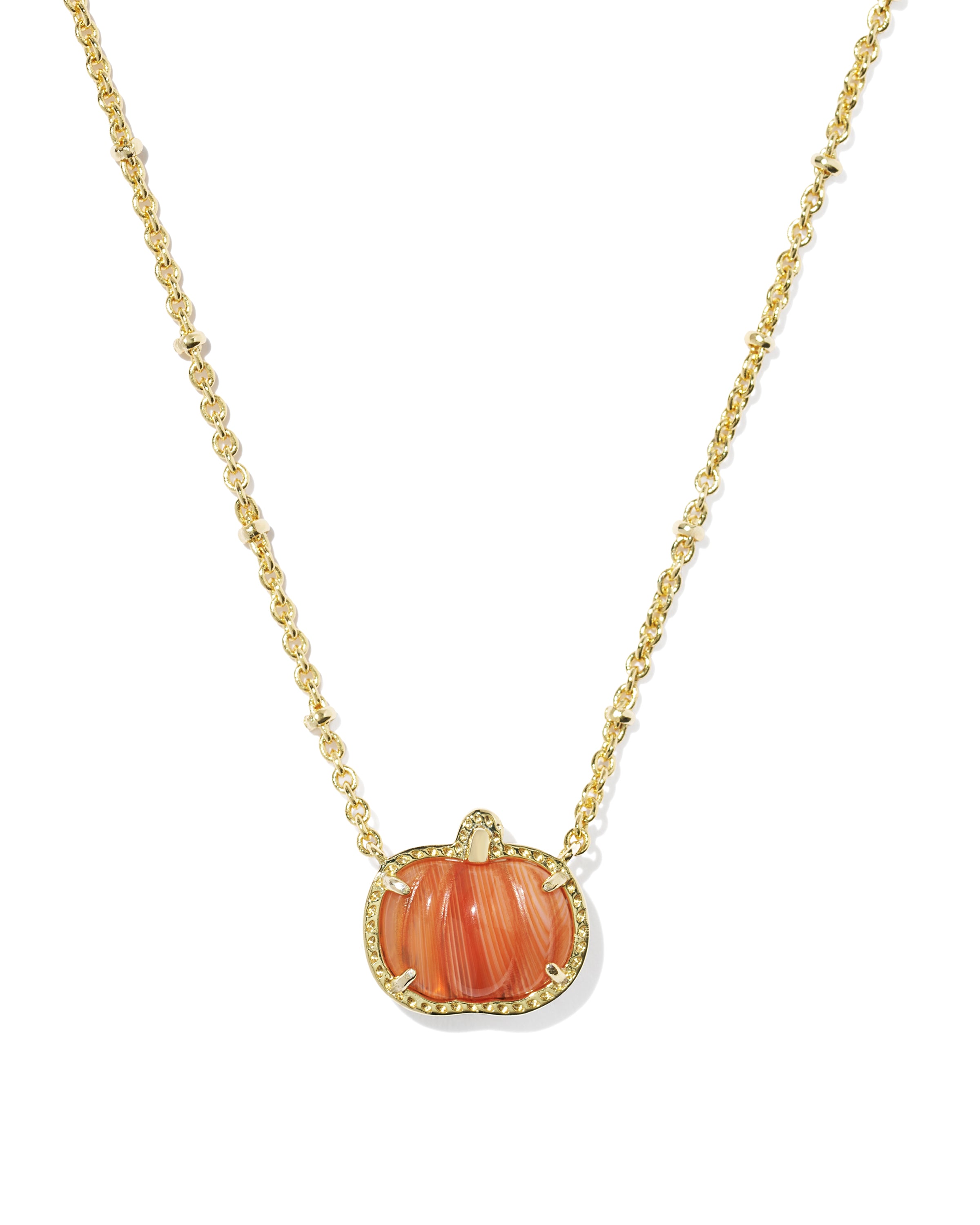 A gold chain necklace featuring a pumpkin-shaped pendant with a carved orange-pink shell center and a border of small clear stones, shown on a plain white background.