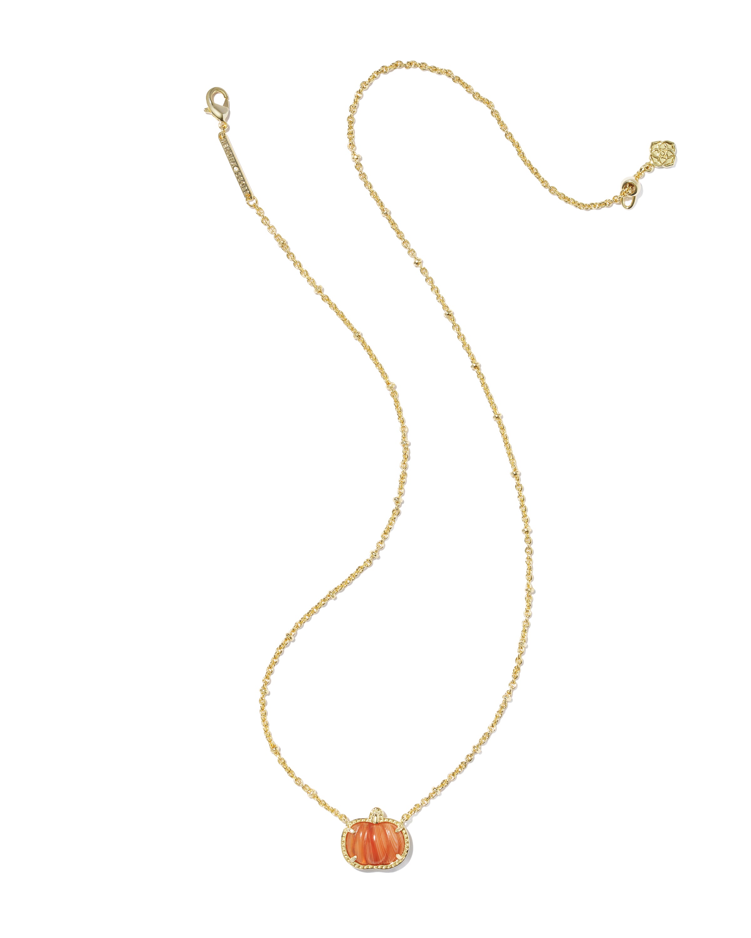 A delicate gold chain necklace featuring a small orange pumpkin pendant with a halo of clear stones, displayed on a clean white background.