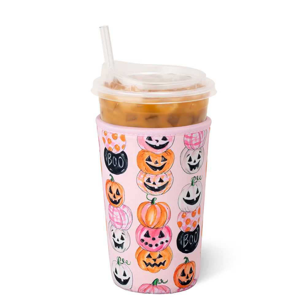 A pink insulated coozie decorated with a pattern of hand-drawn orange, pink, and white pumpkins and black 'BOO' signs, shown on a white background.