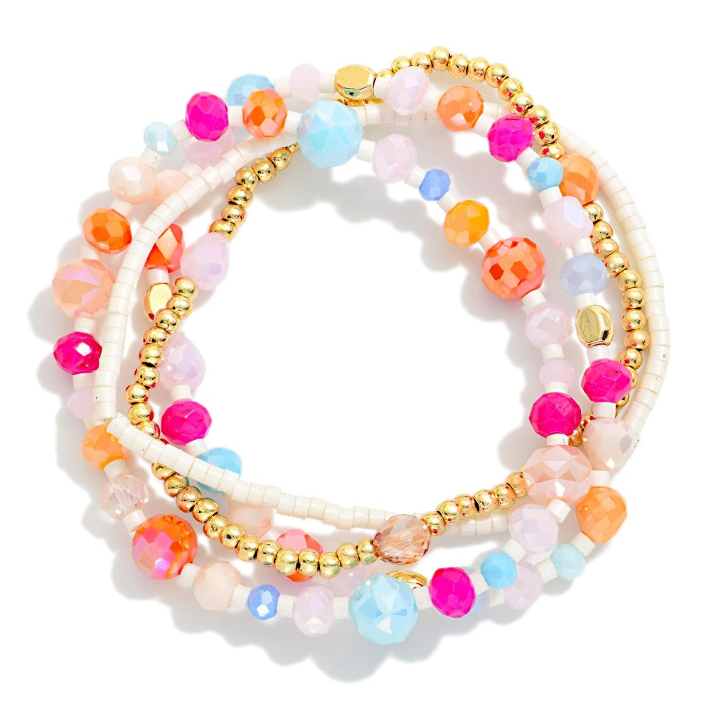 Beaded bracelet set with gold and rainbow beads on a white background.