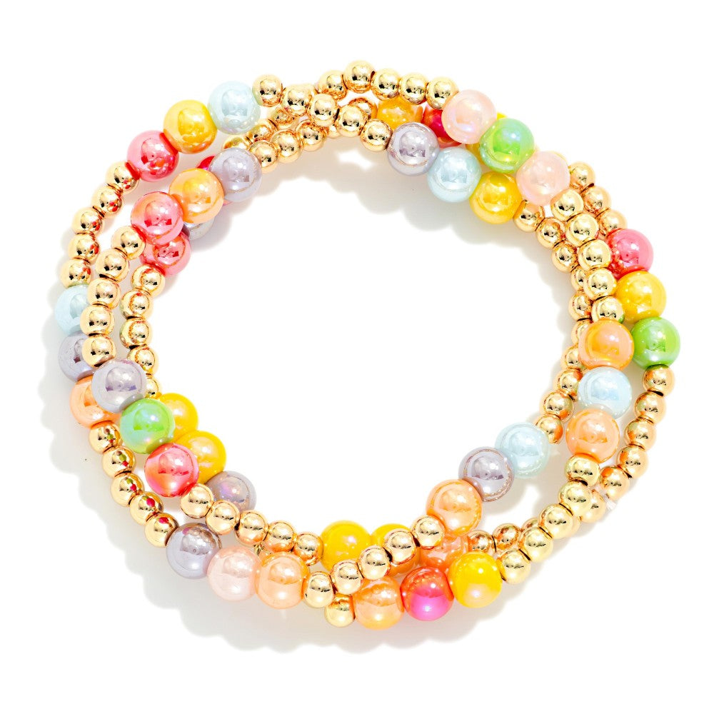 Set of colorful beaded bracelets on a white background