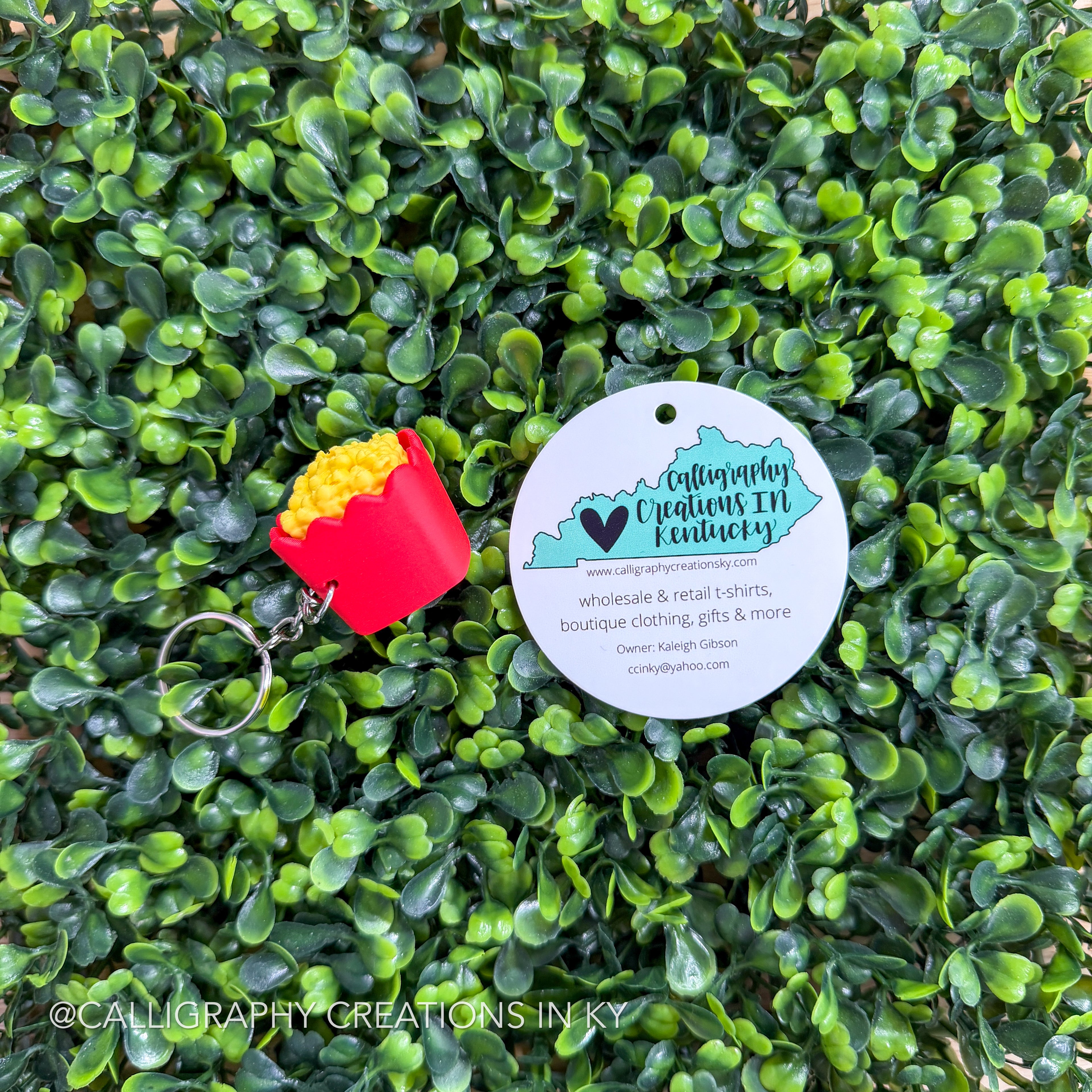 Red popcorn fidget keychain on greenery background with Calligraphy Creations branding