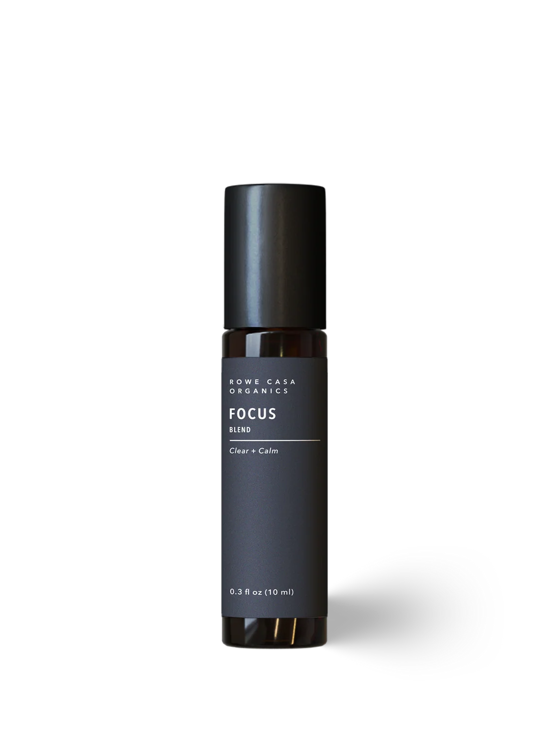A dark charcoal gray roll-on bottle with a black cap, labeled 'ROWE CASA ORGANICS FOCUS BLEND Clear + Calm', centered on a white background with a soft shadow.
