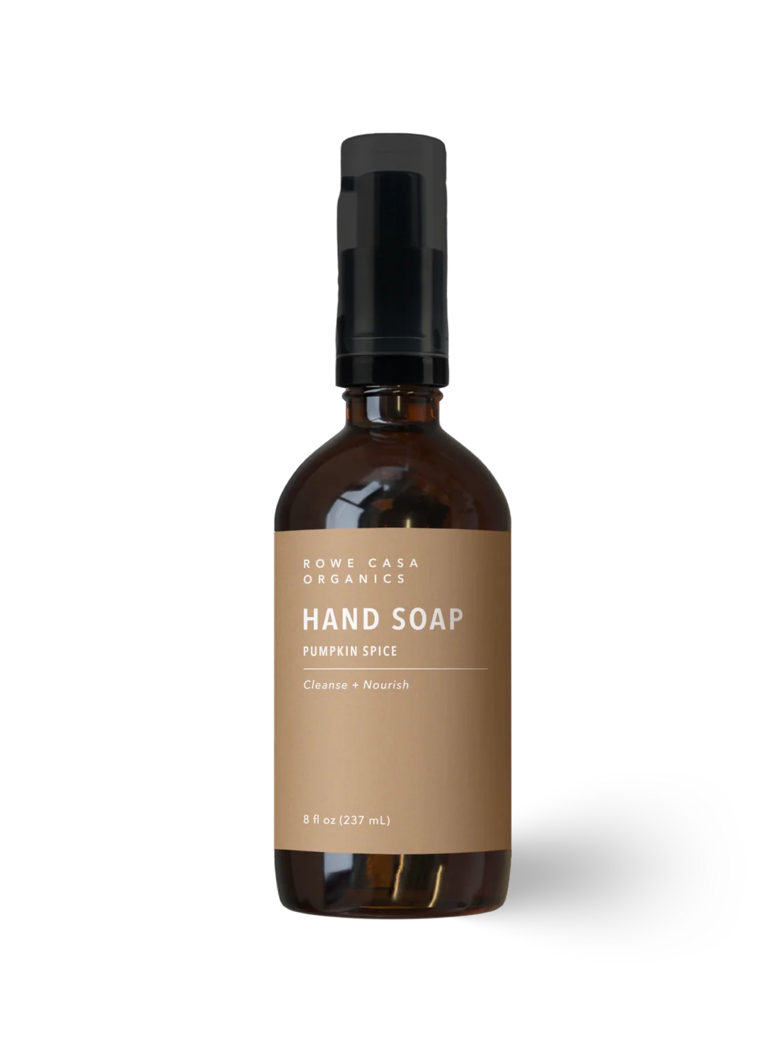 A bottle of Rowe Casa Organics Hand Soap in Pumpkin Spice scent, featuring an amber glass bottle, a brown label, and a black pump cap, set against a plain white background.