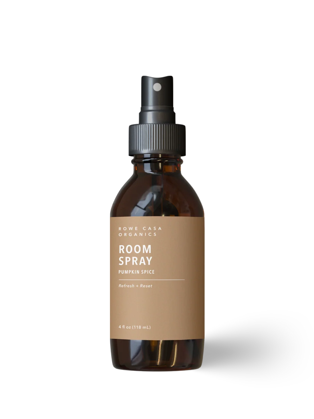 A 4 fl oz amber glass room spray bottle with a black spray nozzle and a tan paper label. The label reads 'ROWE CASA ORGANICS ROOM SPRAY PUMPKIN SPICE'.