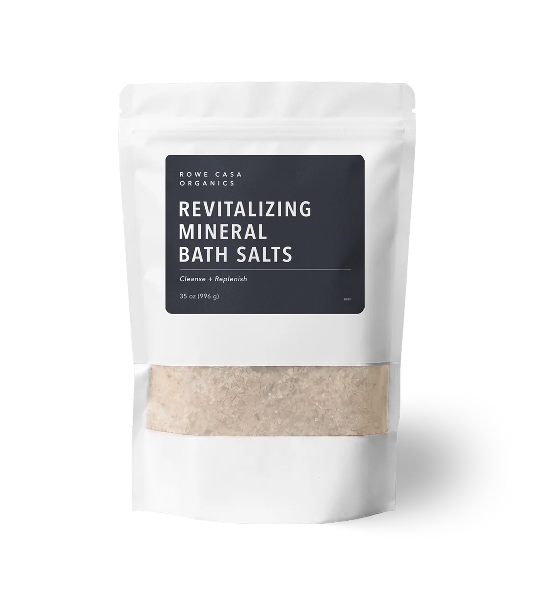 A white stand-up pouch of Rowe Casa Organics Revitalizing Mineral Bath Salts with a black label and a clear window showing the light beige bath salts inside, on a white background.