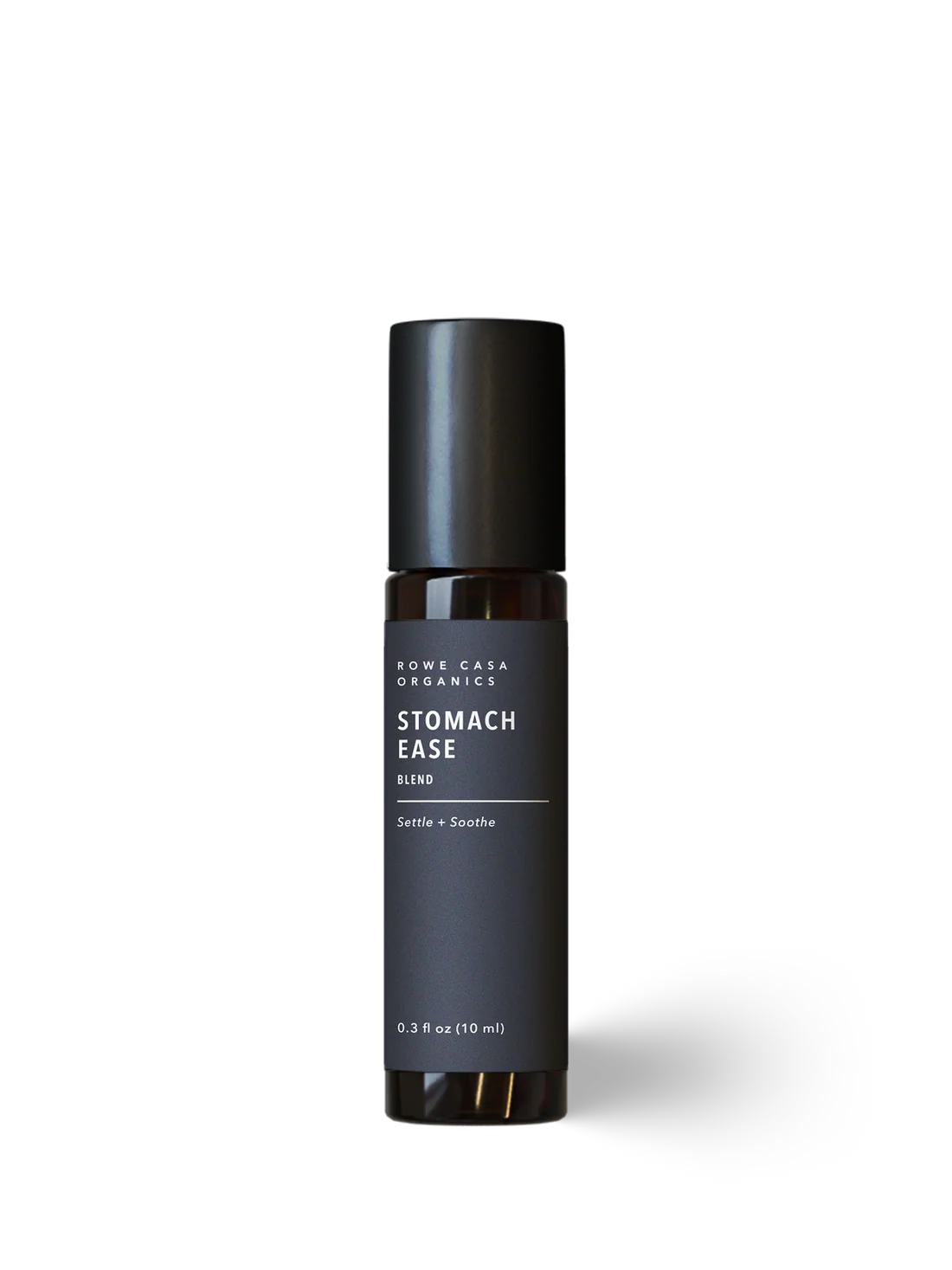 A dark brown glass roll-on bottle with a matte black cap and a dark gray label reading 'ROWE CASA ORGANIC STOMACH EASE BLEND' on a clean white background.